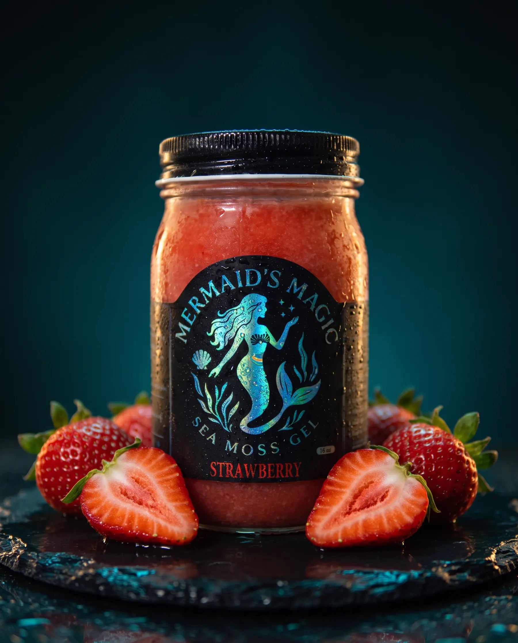 Fresh whole strawberries beside a jar of Mermaid's Magic sea moss gel